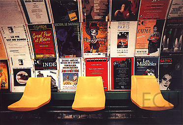 Color photograph of interior of the metro stop Arts-et-M&eacute;tiers in the 3rd arrondisement, Paris featuring classic advertisement posters characteristic of Paris m&eacute;tro